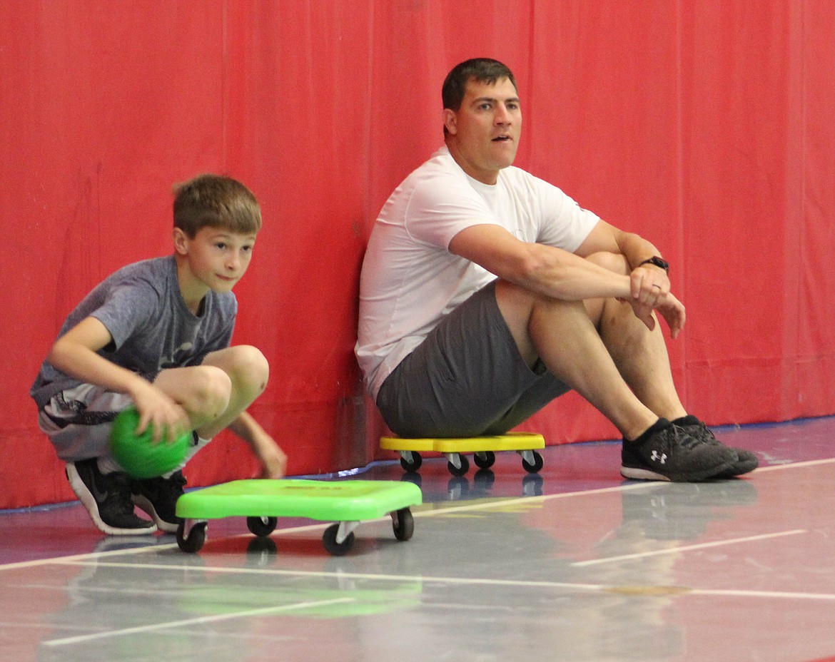 Superior Elementary Principal plays with students in the school gym during their summer camp on Wednesday, June 26. (Maggie Dresser/Mineral Independent)