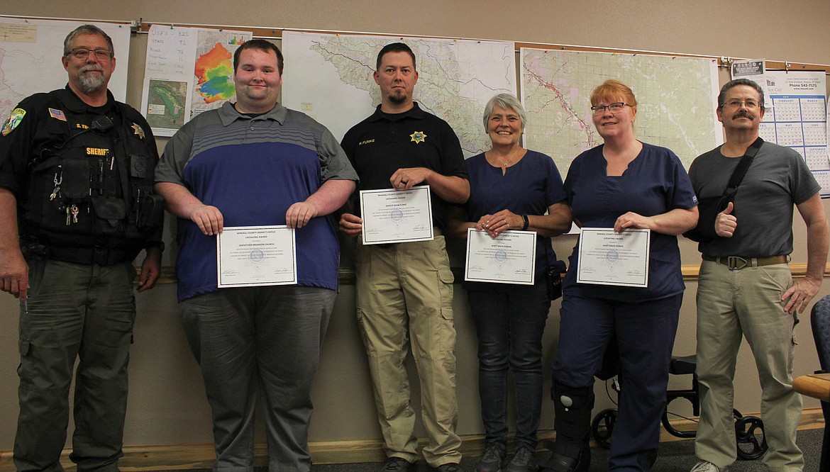 From left, Undersheriff Steve Trollope, dispatcher Brandon Church, Deputy Ryan Funke, EMT Anita Parkin, EMT Angie Parkin and Sheriff Boone.