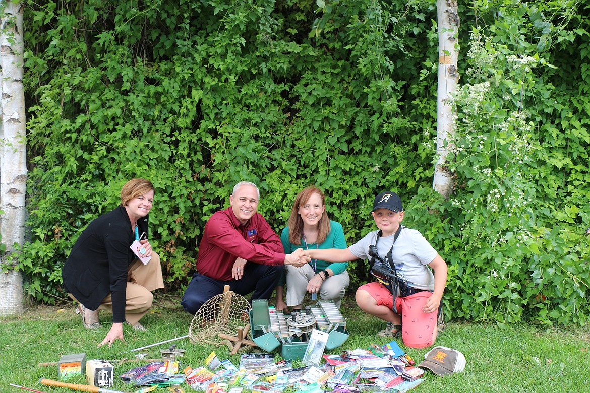 Photo by JENNIFER WRIGHT
From left, Daily Bee general manager Terry Rollman, Hagadone Media Group publisher Clint Schroeder, Daily Bee managing editor Caroline Lobsinger present Max Solis with gifts from the community to replace fishing gear that had been stolen from the young angler last week.