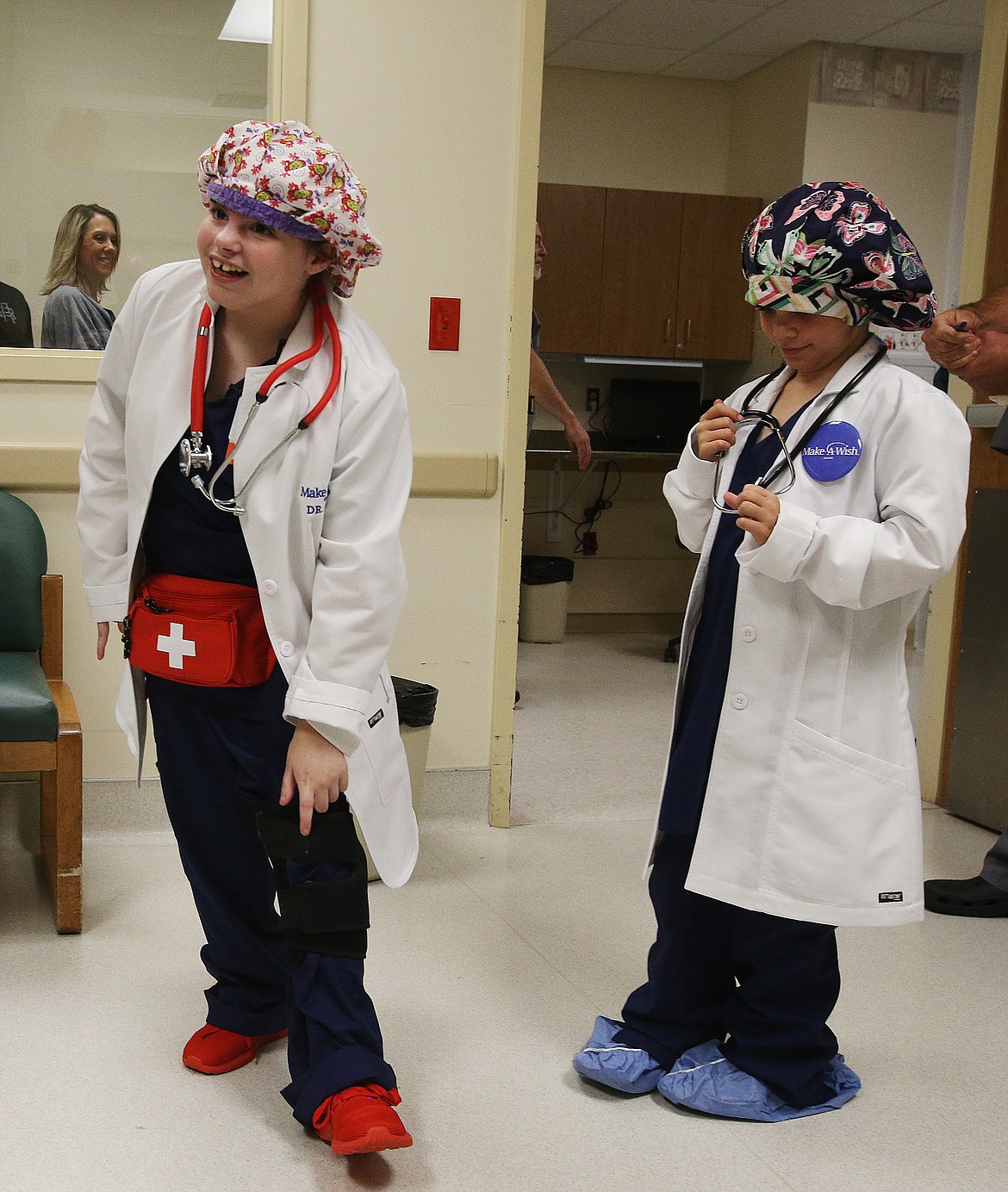 One of the requests of Lizzy Olson's wishes was red shoes because she knows surgeons need to wear shoes that can get dirty in the operating room. On her right is her &quot;nurse&quot; sister Katherine. (LOREN BENOIT/Press)