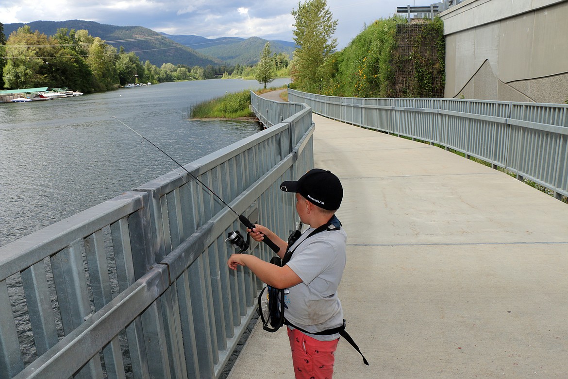 (Photo by CAROLINE LOBSINGER)
Max Solis finds a spot to fish along Sand Creek&#146;s eastern bank near his favorite fishing spot by the stairs leading to the Cedar Street Bridge Public Market in search of bass.