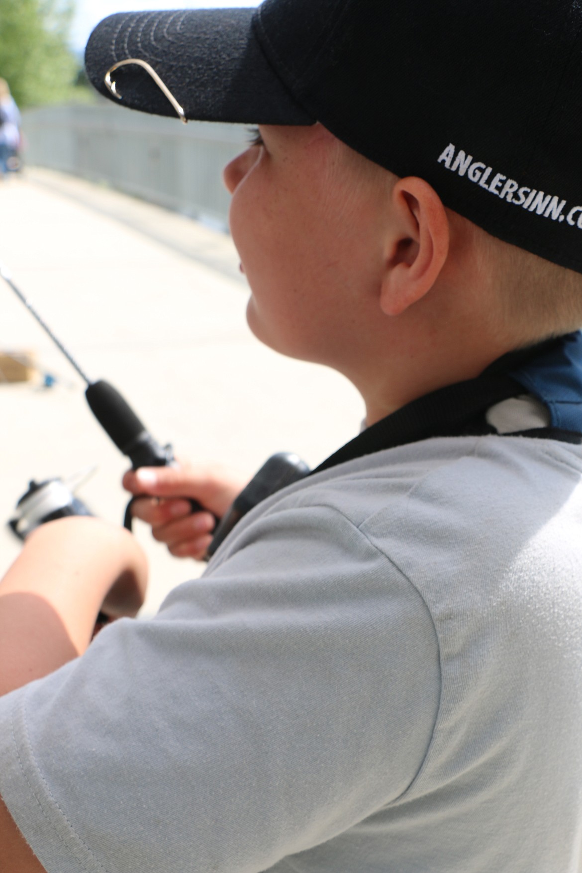 (Photo by CAROLINE LOBSINGER)
A lucky hook has a prominent spot on Max Solis&#146; cap as he finds some time Thursday to go fishing along Sand Creek.