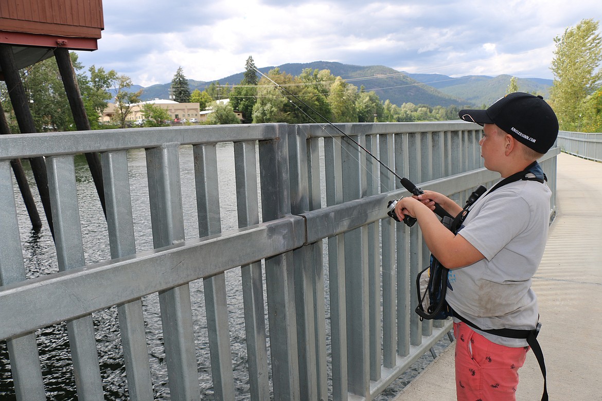 (Photo by CAROLINE LOBSINGER)
Max Solis finds a spot to fish along Sand Creek&#146;s eastern bank near his favorite fishing spot by the stairs leading to the Cedar Street Bridge Public Market in search of bass.