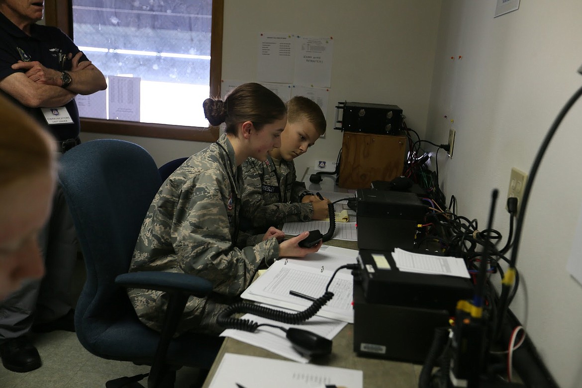 Courtesy photo.
Cadets Hannah Hoatson, 15, and Travis Traves, 12, use radios to signal aircraft overhead.