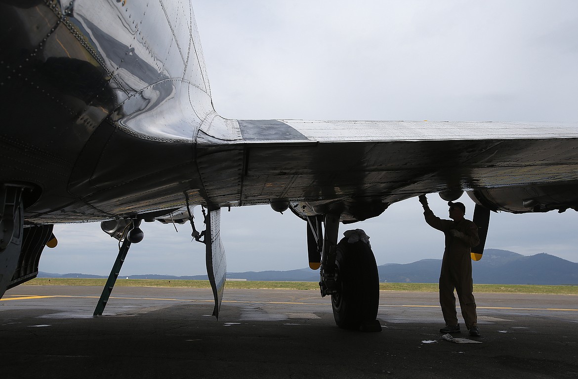 Crew member Bill Croutch cleans the wing of a B17 Flying Fortress Monday prior to this weekend&#146;s Coeur d&#146;Alene Air Expo. (LOREN BENOIT/Press)