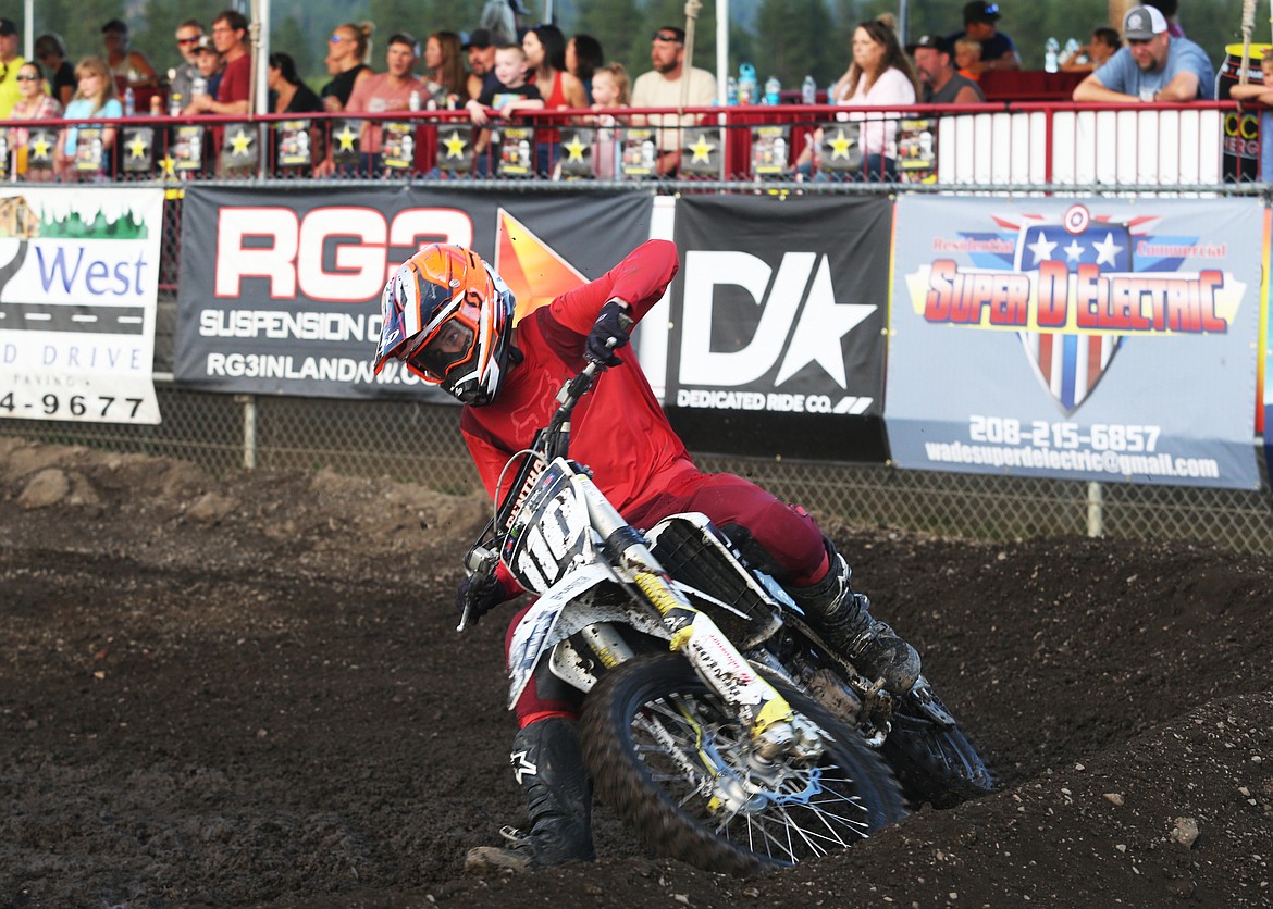 Trevor Scoffield rides his bike around a sharp turn in the 250 Beginners Division 1 arenacross race Friday night.