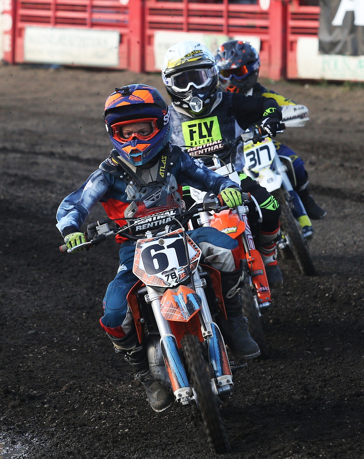 Bryce Mcalister leads a pair of bikers around a turn in the 66cc Open arenacross race Friday night.