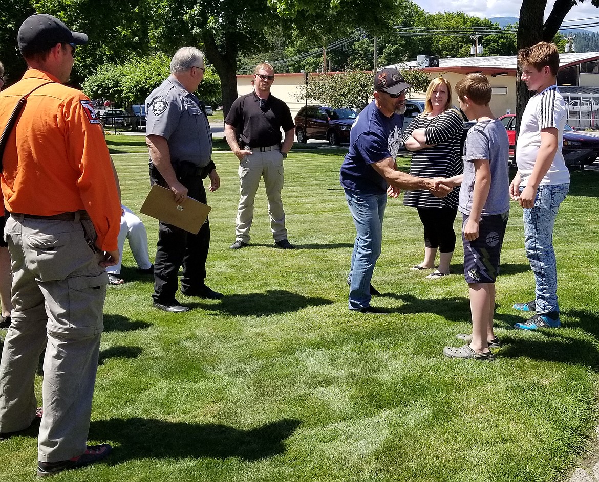 (Photo by MANDI BATEMAN)
Fourth of July organizer, Gary Leonard, shakes Brennan Johnson&#146;s hand.