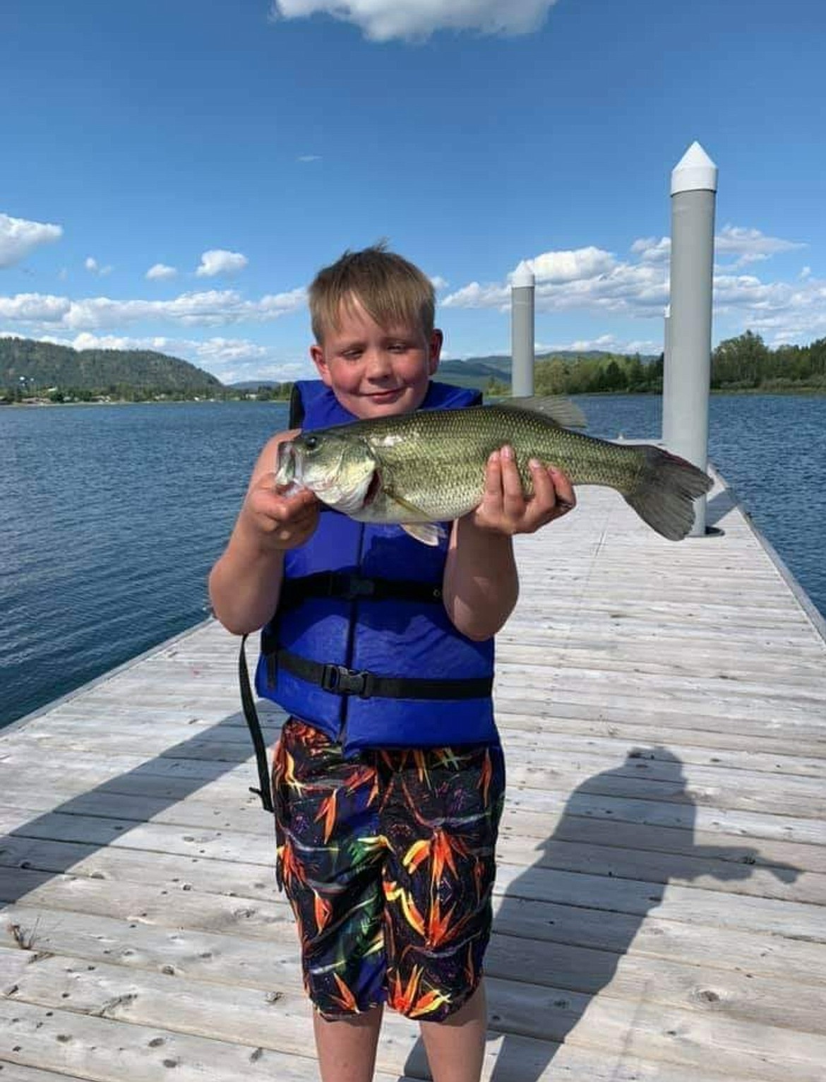 Max Solis, 8, proudly displays a bass he caught about three weeks ago off the dock at Fat Bass Restaurant and Bar in Sandpoint. The young yet avid fisherman had his tackle box stolen when he had his back turned while fishing Thursday afternoon.