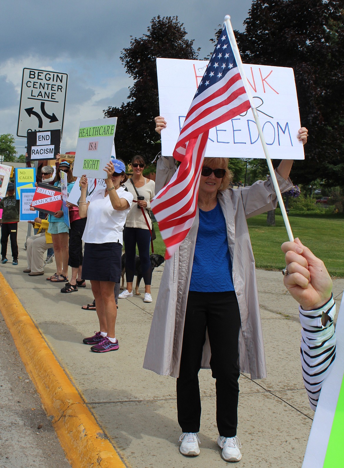 Arlene Ross, the mother of two sons with a history of military service, holds a &#145;Honk for Freedom&#146; sign during a Resist Trump rally Tuesday along Main Street in Kalispell. (Duncan Adams/Daily Inter Lake)