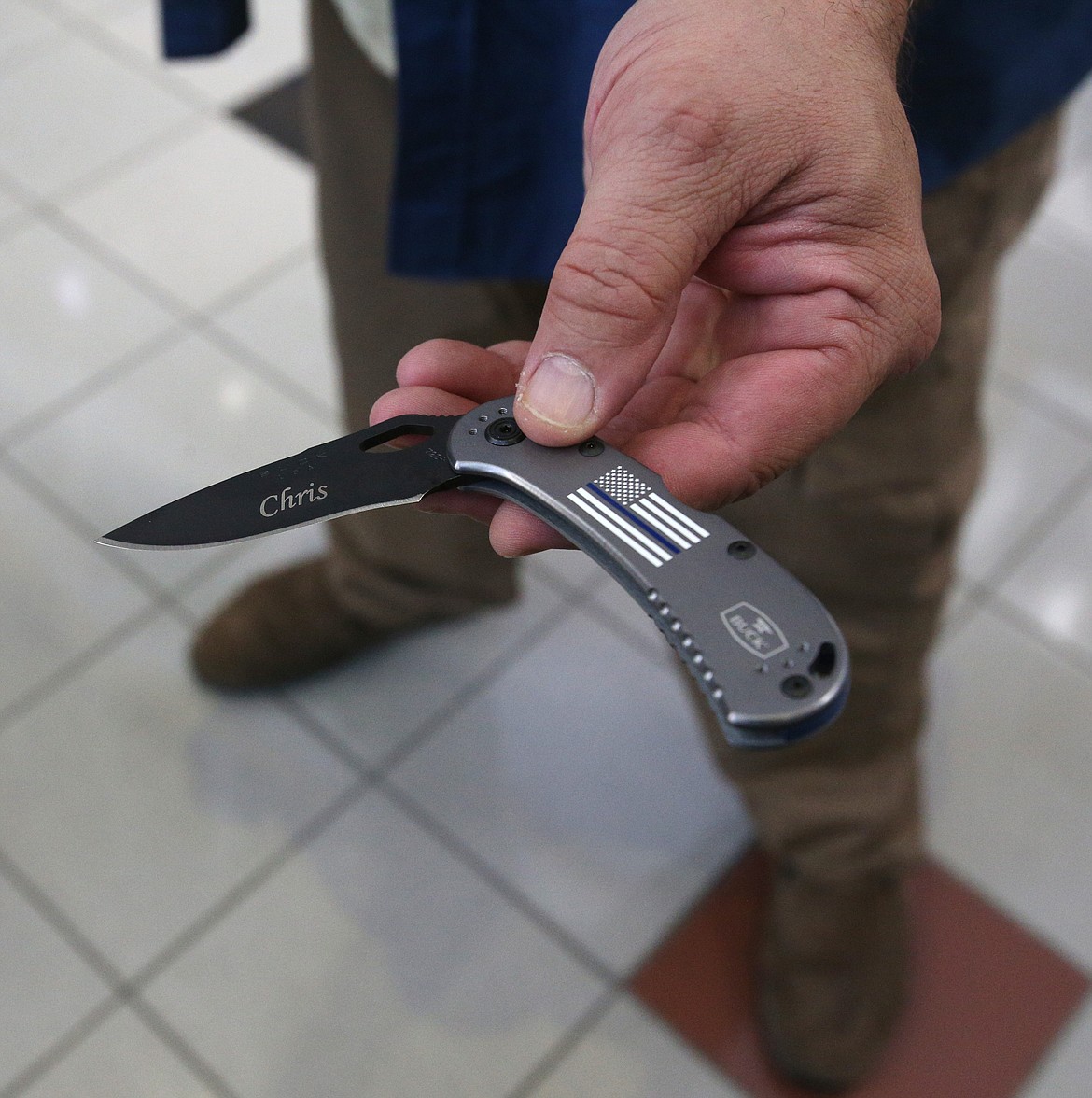 Joe Vogel thanked Officer Chris Christensen for saving his life. He gifted Officer Christensen this Buck knife his son made. (LOREN BENOIT/Press)