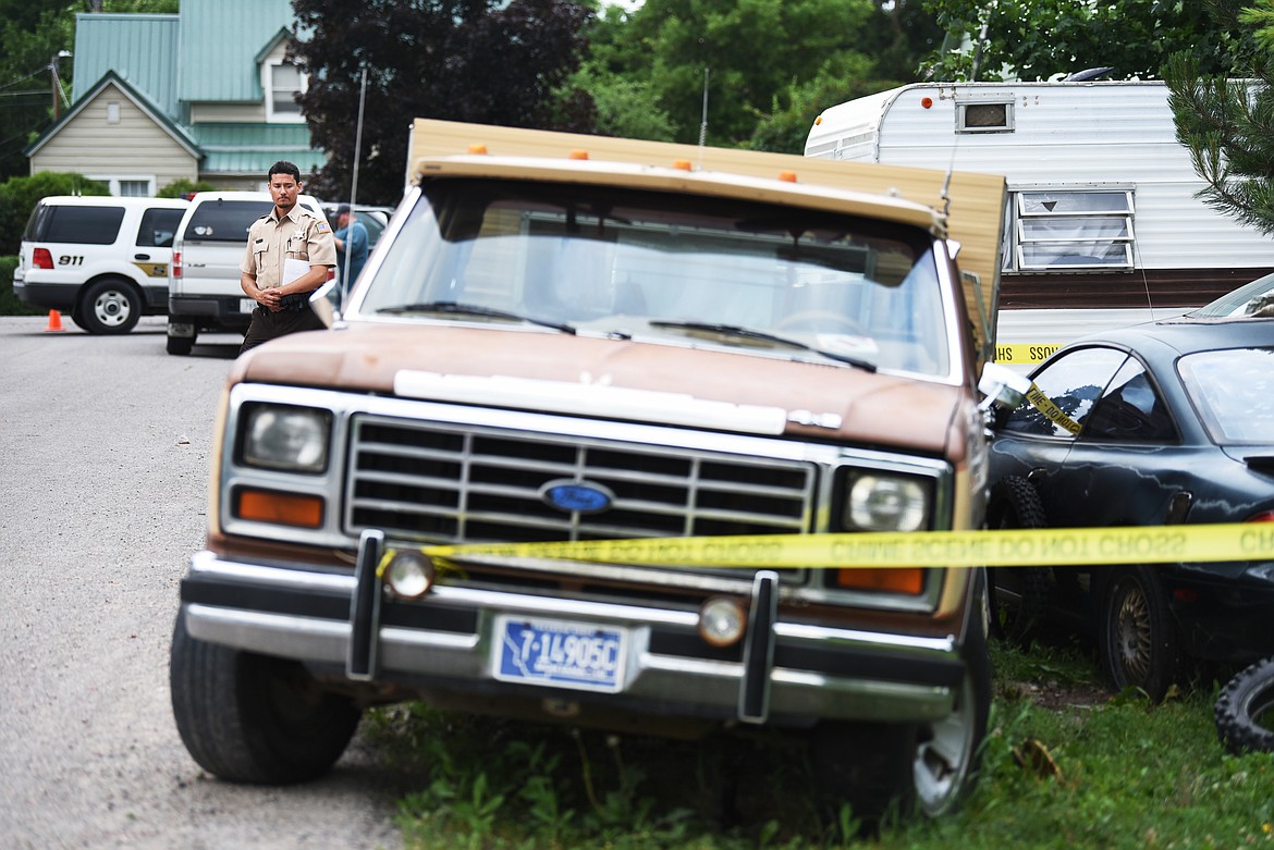 Juan Rivera Strangberg of the Flathead County Sheriff's Posse stands guard at the scene of a homicide on Monday evening, July15, in Evergreen. The identity of the man killed was not available as next of kin had not yet been able to be contacted.(Brenda Ahearn/Daily Inter Lake)