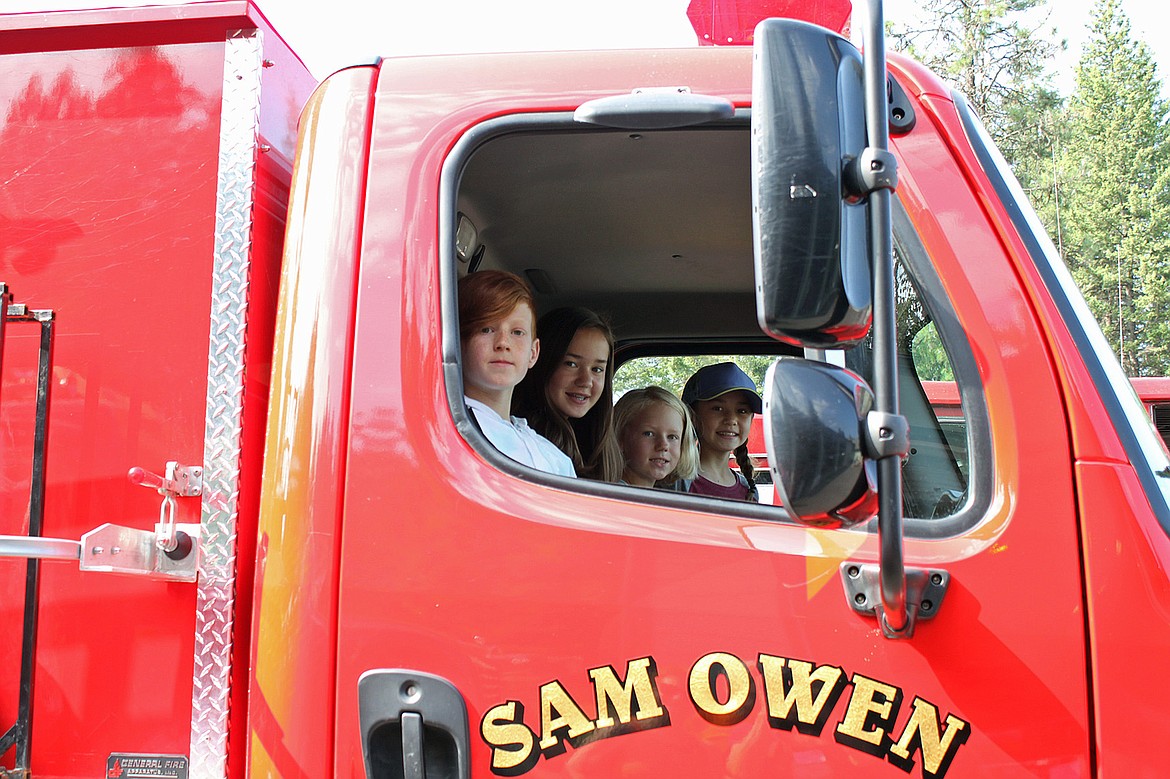 Area youngsters enjoy the view from a Sam Owen Fire District fire engine at a past pancake breakfast put on by the fire district. This year's event will be Saturday, July 23.