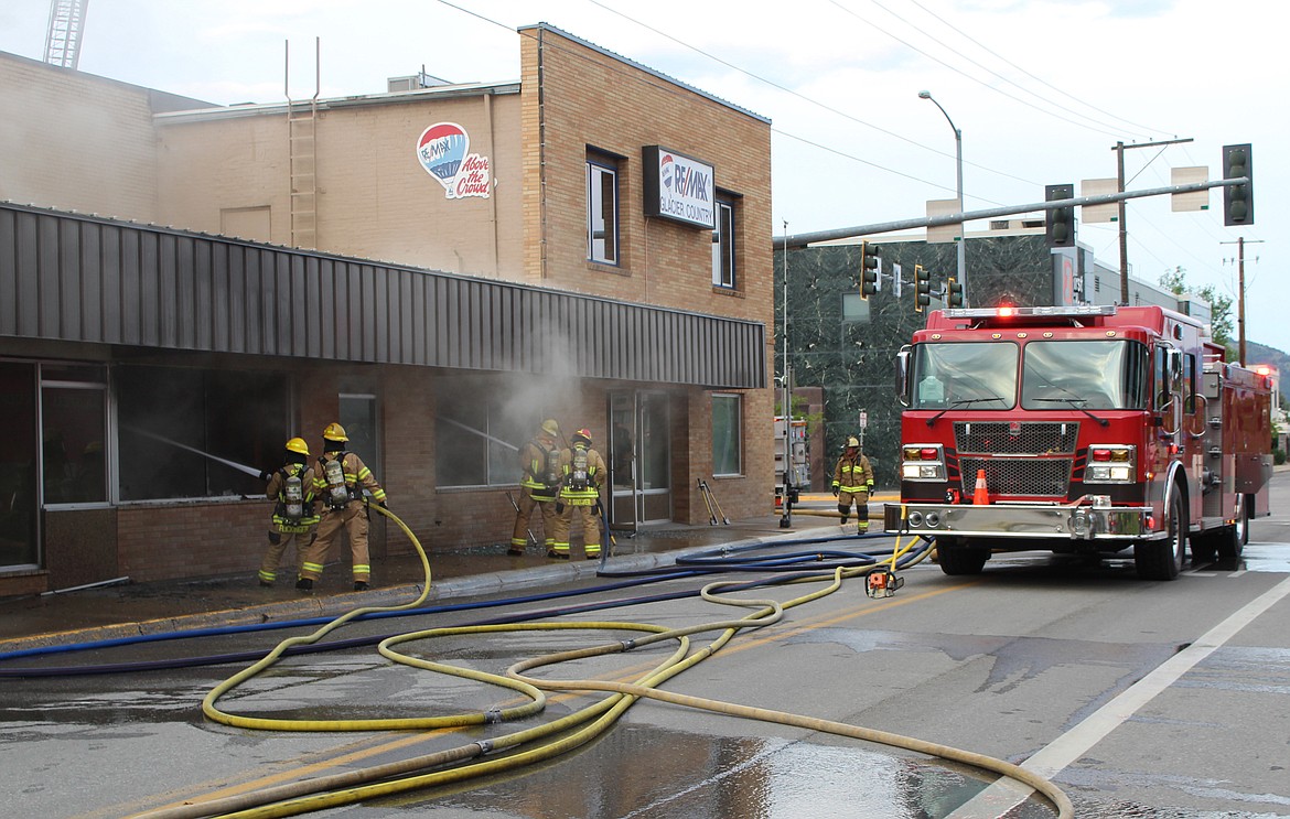 Firefighters were forced to retreat at times from the intense smoke from the fire in the Re/Max Glacier Country building.