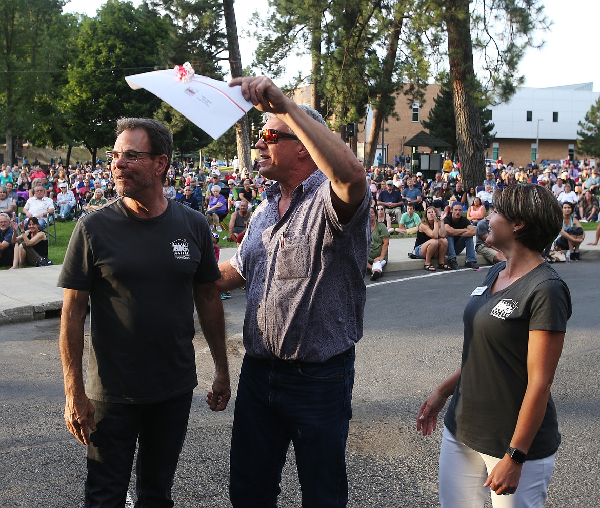 Lee Bernardi reacts to winning the $20,000 prize at NIC's Really Big House Raffle on Wednesday. On his left, NIC President Rick MacLennan. On right, NIC Foundation President Jody Azevedo. (LOREN BENOIT/Press)