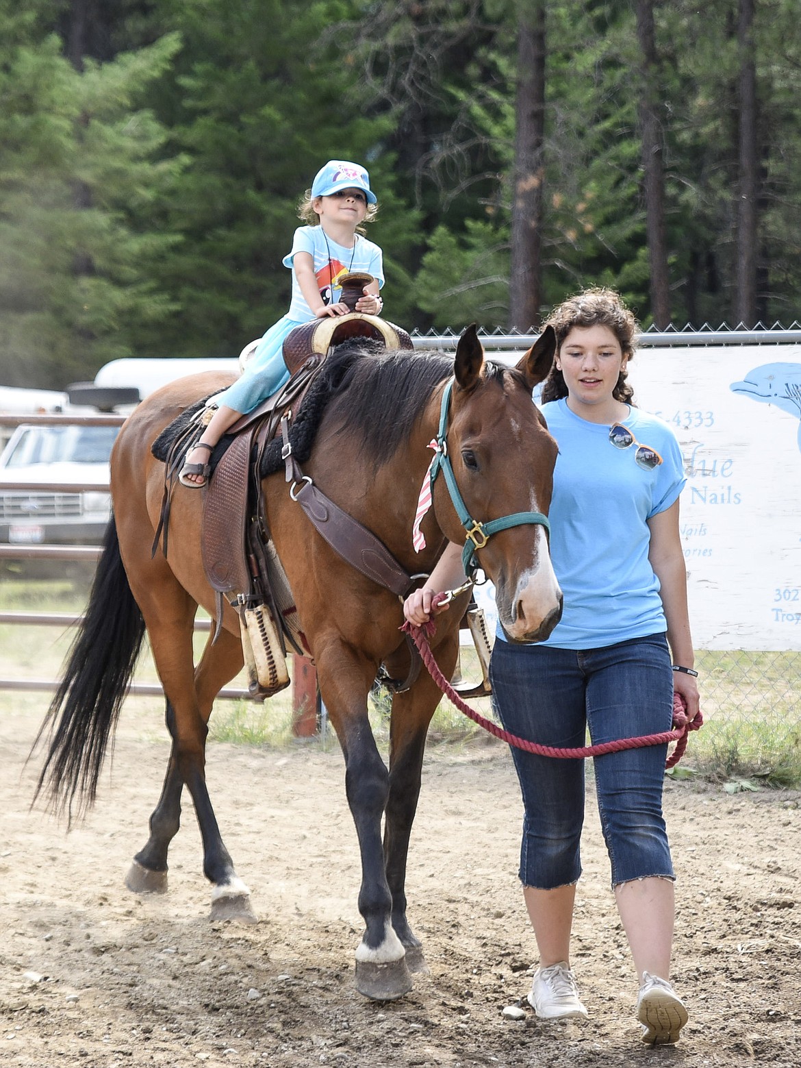 Kylee McKinney takes a horse ride as Lanae Vistica guides, at the Three Lakes Roundup, put on by Three Lakes Community Bible Church, Saturday. (Ben Kibbey/The Western News)