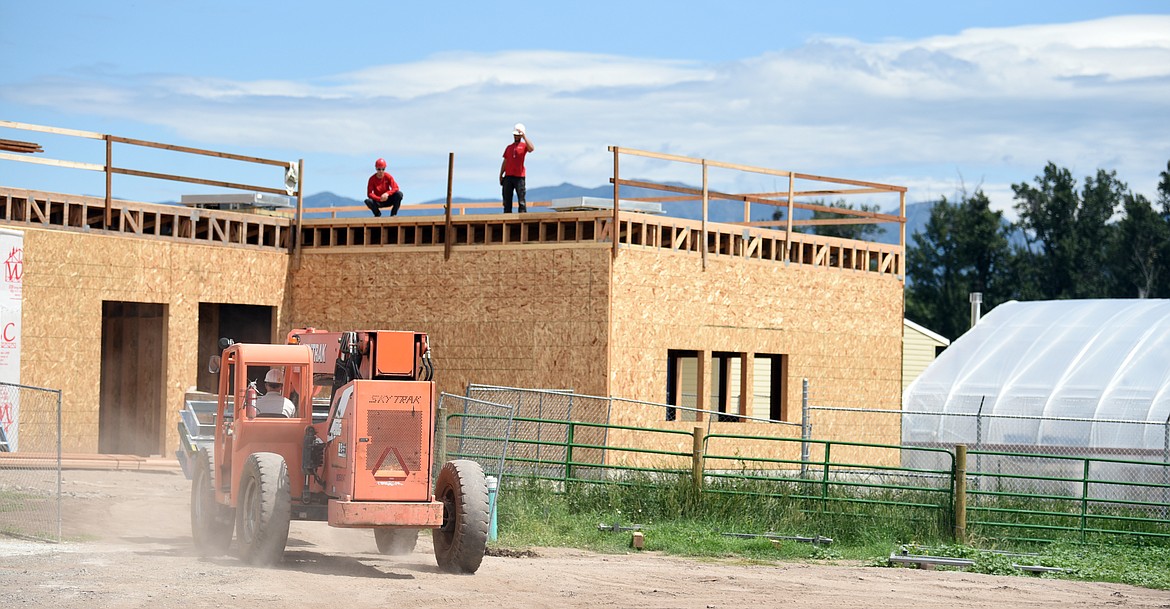 Construction crews work on a classroom addition being built at the H.E. Robinson Vocational Agriculture Center on Thursday in Kalispell. (Brenda Ahearn/Daily Inter Lake)
