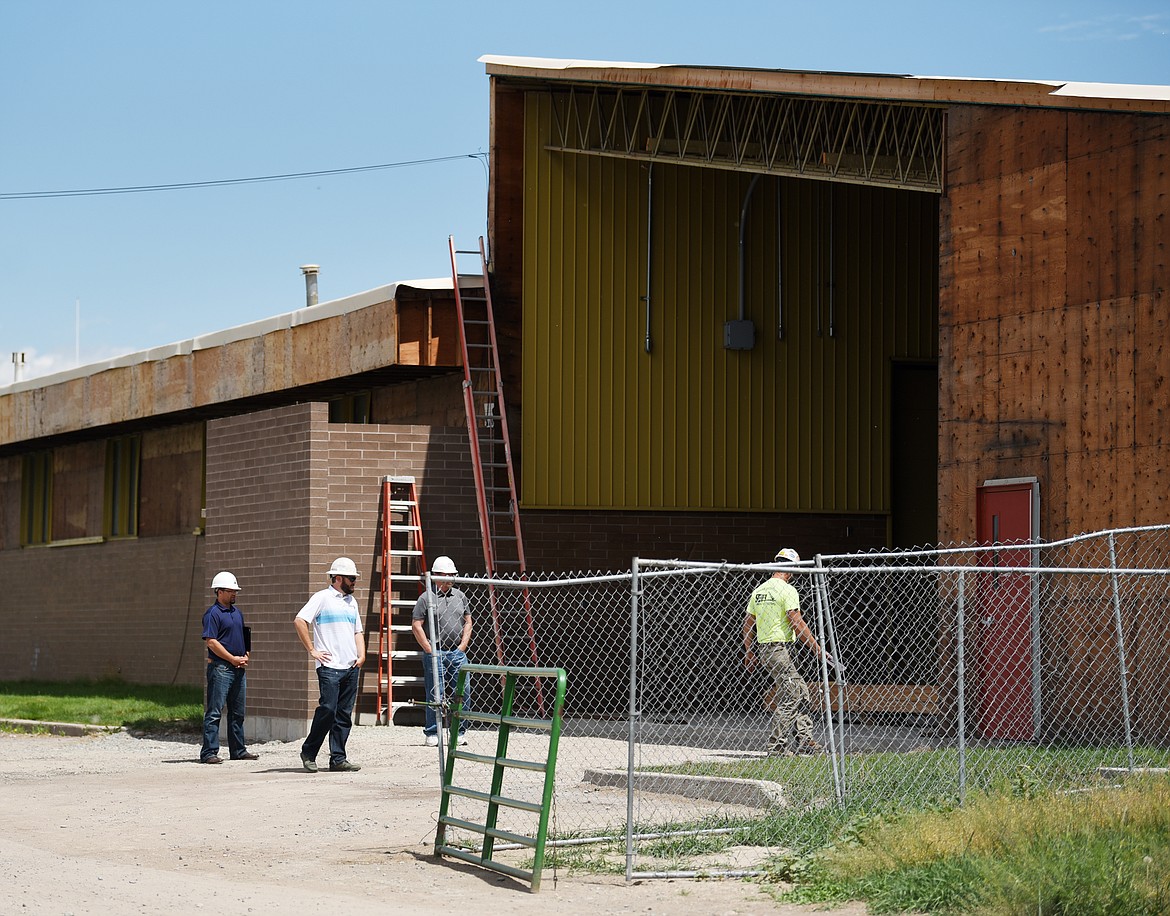 Construction of the welding shop addition at the H.E. Robinson Vocational Agriculture Center is discussed on Thursday, July 11, in Kalispell. (Brenda Ahearn/Daily Inter Lake)