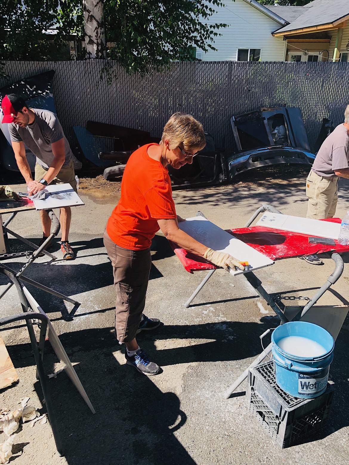 KHS family and consumer sciences teacher Janet Dose works on sanding a cupboard door before it gets painted.