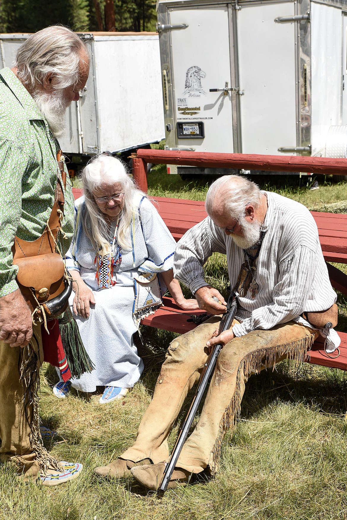 Tony Roberts, from Colfax, Washington, uses compressed air to clear a stuck round from the barrel of a black powder rifle for Jack and Connie Oar at the Two Rivers Rendezvous Saturday. (Ben Kibbey/The Western News)