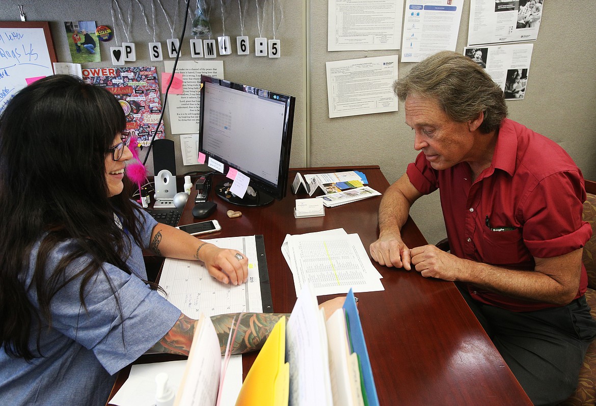 Shelter Manager Amberly Bunch helps Doug Wetzig with his paperwork Tuesday at the St. Vincent de Paul Help Center. (LOREN BENOIT/Press)