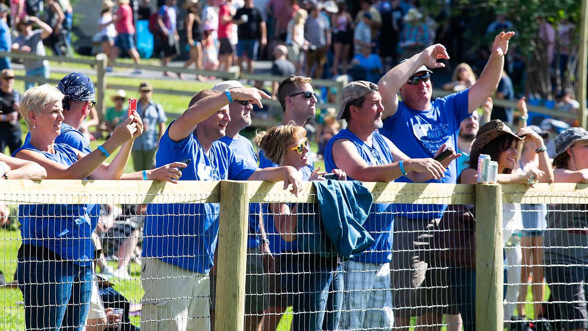 The Govenettio family, left, brought 19 siblings and in-laws from Buffalo, New York, to watch Leonard Govenettio perform with Jameson and the Sordid Seeds at the Under the Big Sky festival on Saturday. The family surprised Leonard, who has lived in Whitefish since 2003, before the concert, and the group was at the front of the line to cheer him on during the festival &#151;&#160;complete with matching shirts. Leonard&#146;s brother Dominick said it was an emotional experience, and he&#146;s grateful to have been able to support Leonard with the family. &#147;He never had prom, never had a big wedding, never had a birthday party,&#148; Dominick said. &#147;We were crying. To see him have that moment that all of us took for granted, it was great.&#148; Right, Leonard performs during the festival.