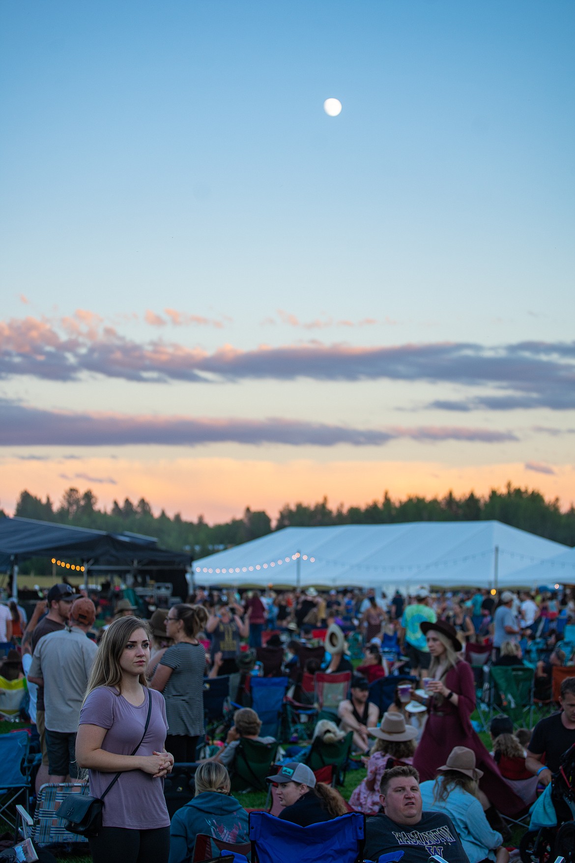 The moon hangs above the crowds during the Under the Big Sky music festival over the weekend at Big Mountain Ranch east of Whitefish. (Daniel McKay/Whitefish Pilot)