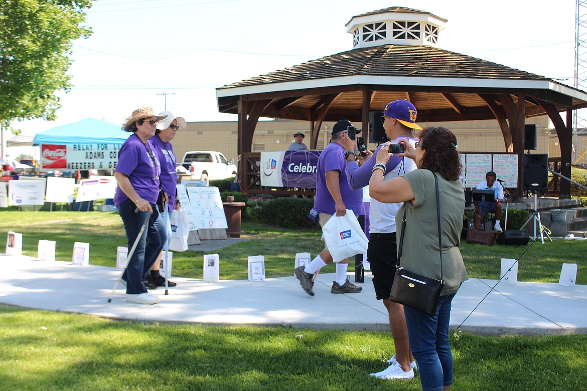 Cheryl Schweizer/Sun Tribune
Cancer survivors led the first lap, and had some fans snap photos, during the Relay for Life in Othello.