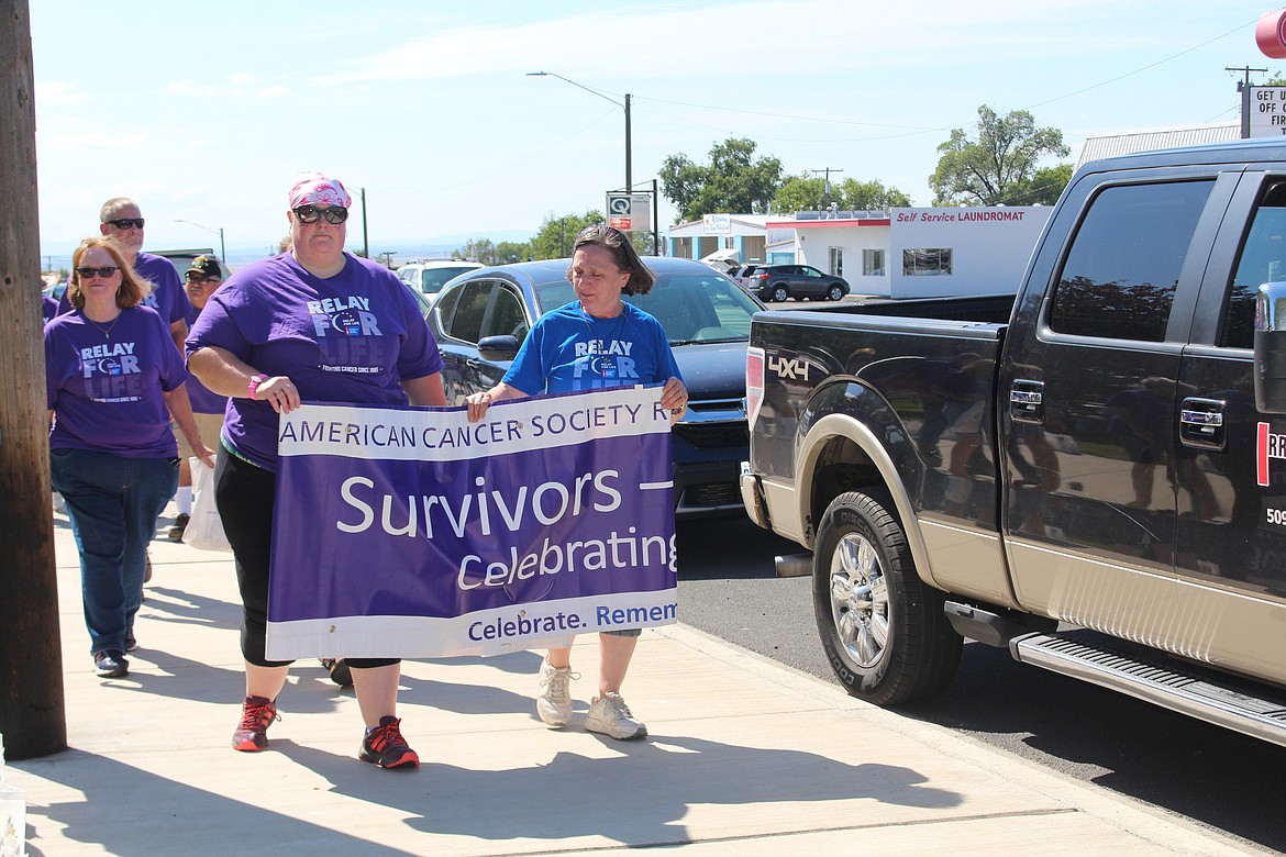 Cheryl Schweizer/Sun Tribune
Cancer survivors walk the opening lap of the Relay for Life in Othello Saturday.