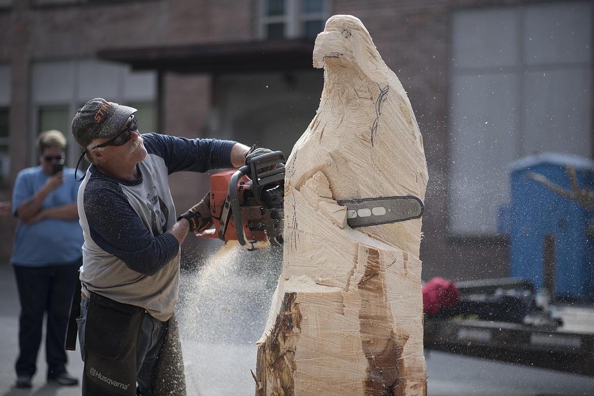 Ron Adamson creates an eagle sculpture during the Ron Adamson's Libby Chainsaw Event, July 4 in Libby. (Luke Hollister/The Western News)