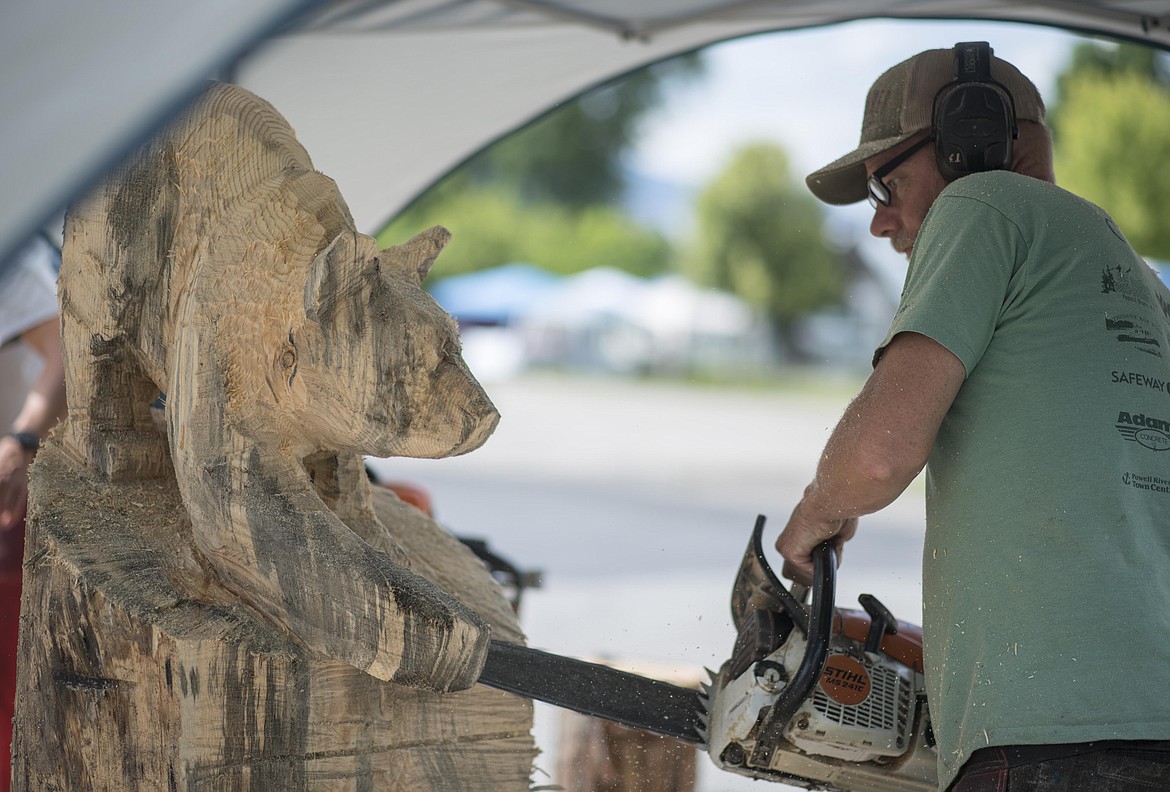 Michael Penny works on an animal sculpture during Ron Adamson's Libby Chainsaw Event, July 4 in Libby. (Luke Hollister/The Western News)