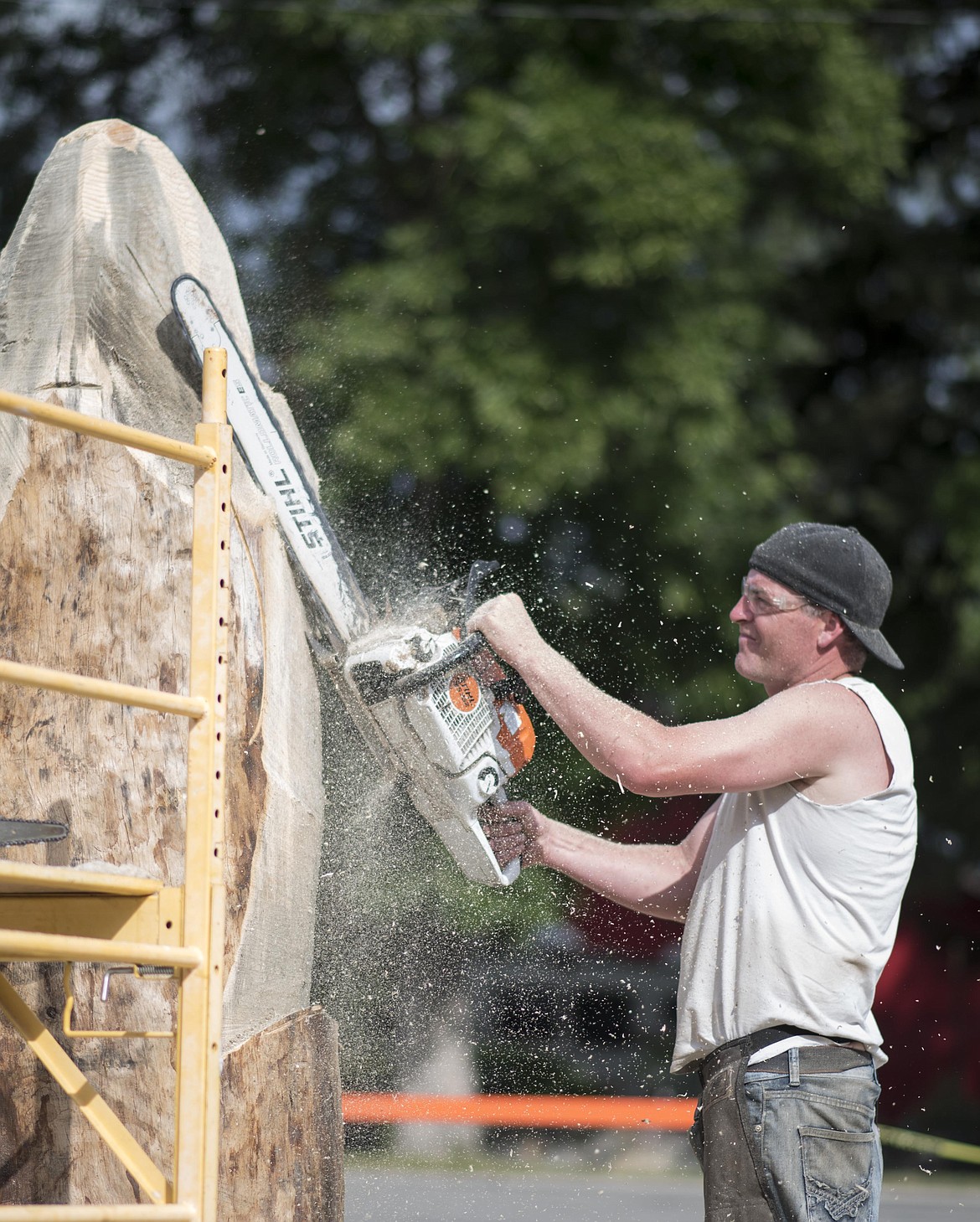 Jeffrey Adamson carves out a new creation with his chainsaw during Ron Adamson's Libby Chainsaw Event, July 4 in Libby. (Luke Hollister/The Western News)