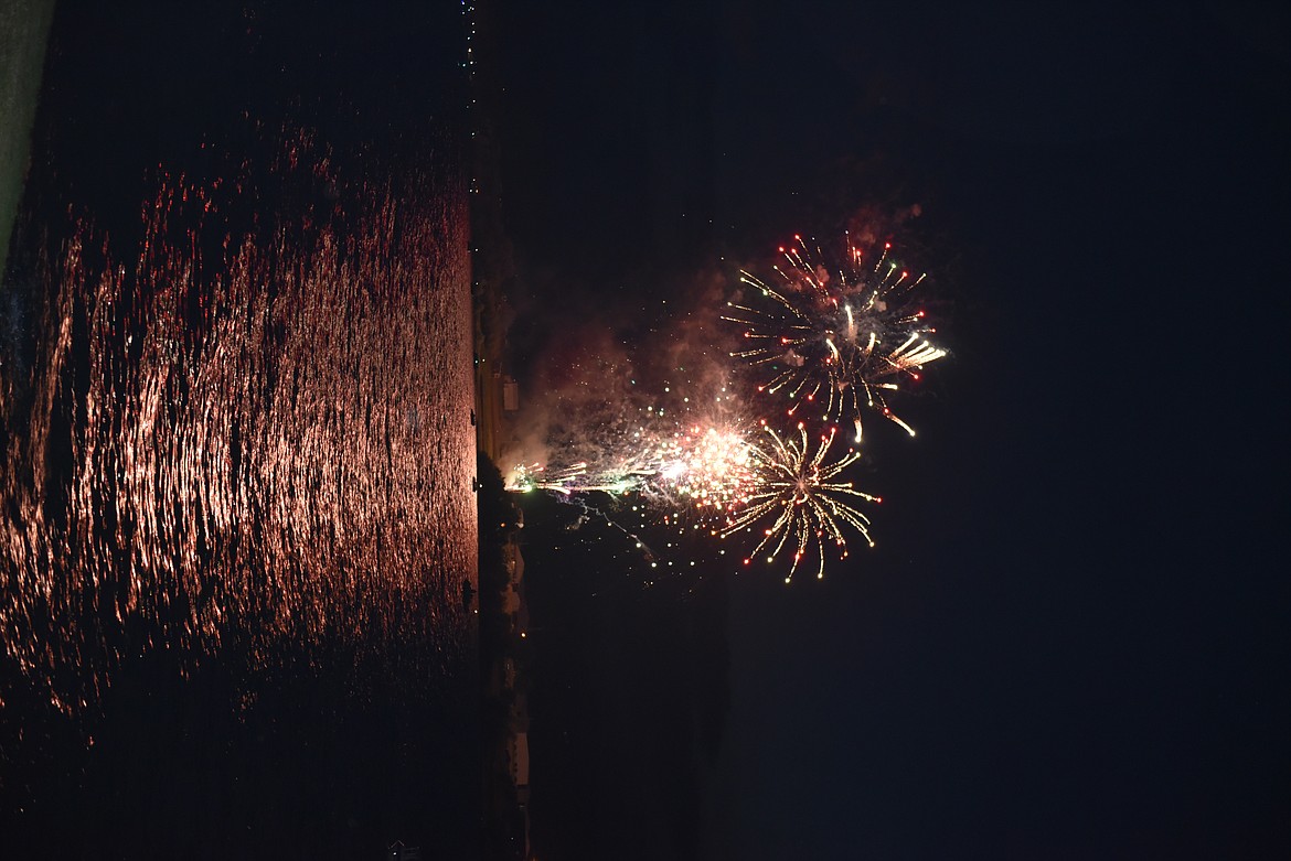 MANY OBSERVERS watch the Fourth of July fireworks on the Flathead River in Polson. (Carolyn Hidy/Lake County Leader)