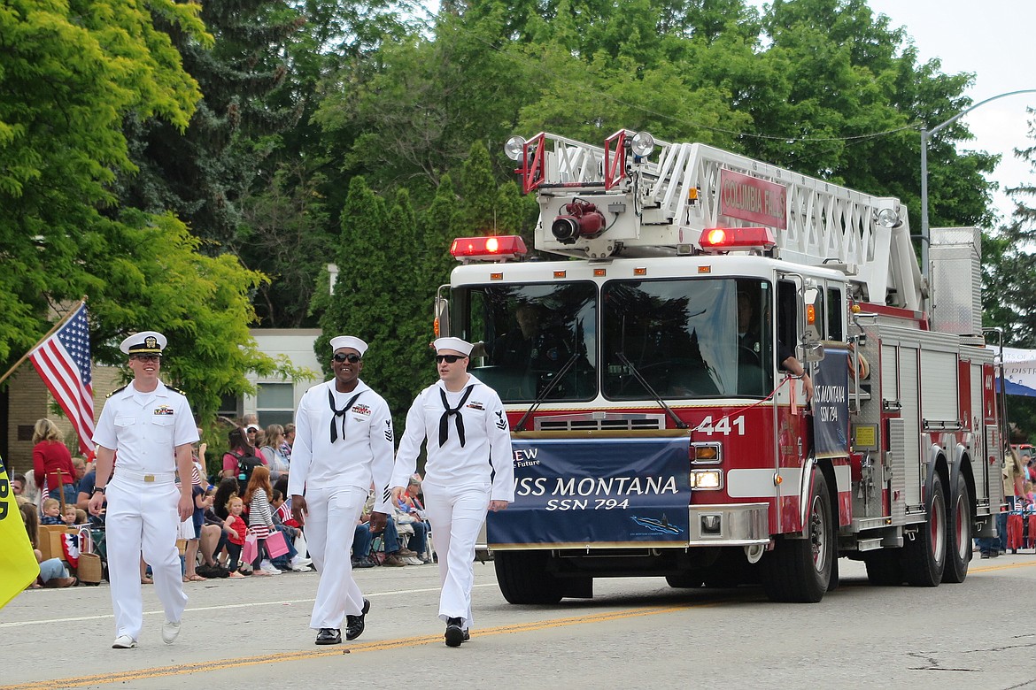 Crew members from the USS Montana lead the Kalispell Fourth of July parade. From left to right: Lt. Aaron Bishop, Petty Officer Marlon Haughton, Petty Officer Tyler Fellows. (Courtesy of Bill Whitsitt).