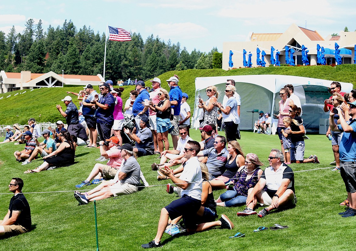 Fans watch former professional baseball, hockey and basketball celebrities tee off to the floating green during the Showcase celebrity golf exhibition Saturday at The Coeur d&#146;Alene Resort Golf Course. (LOREN BENOIT/Press)