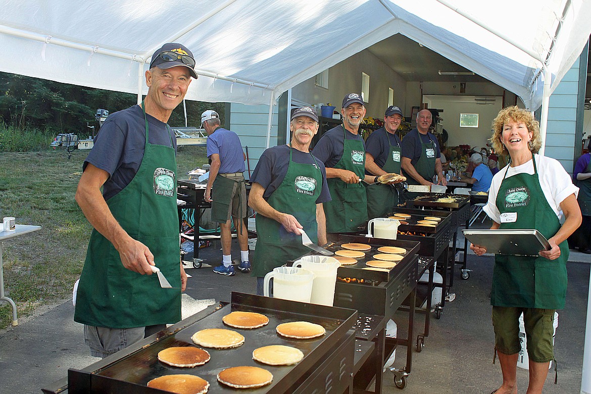 (Photo courtesy SAM OWEN FIRE DISTRICT)Sam Owen Fire District crews cook up flapjacks at last year's pancake breakfast. This year's event is Saturday.