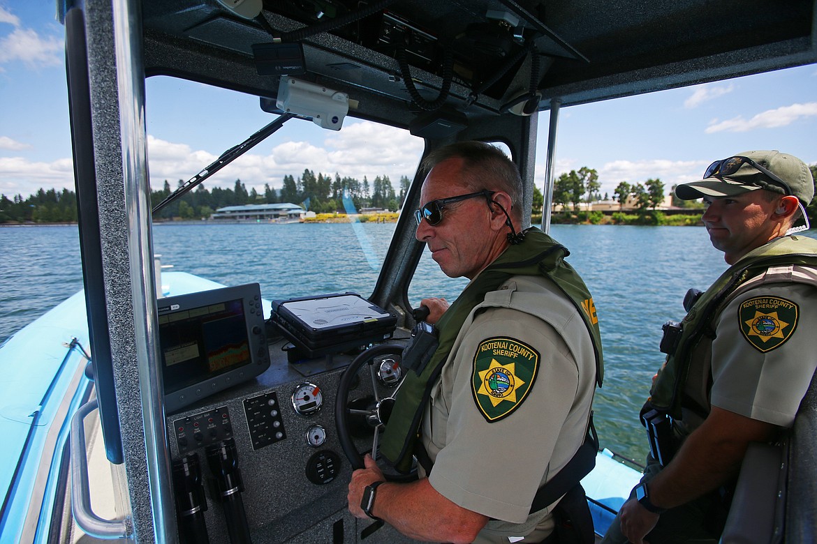 Kootenai County Sheriff Deputies Gerald Wallace, left, Gabriel Joling patrol the Spokane River on Wednesday. (LOREN BENOIT/Press)