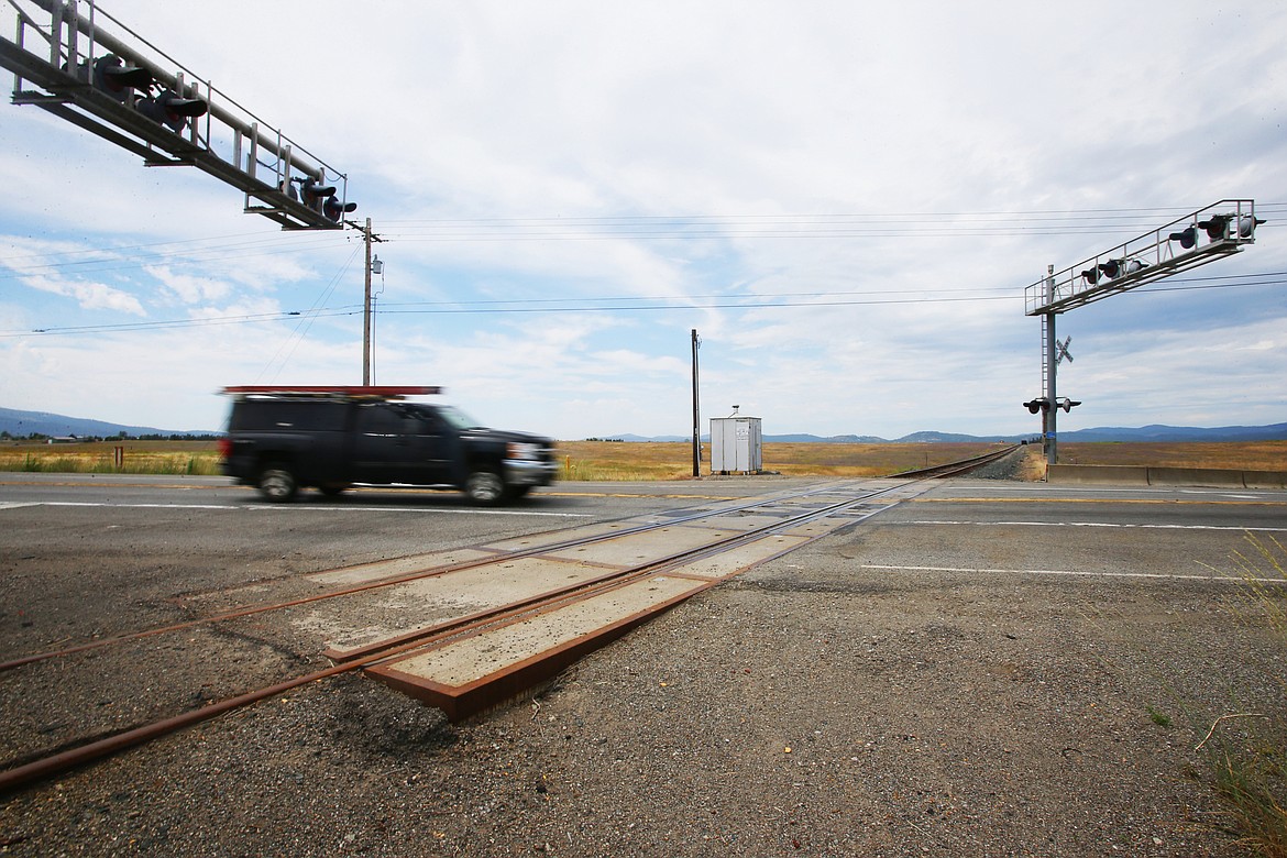 Looking west, a vehicle heads north on Highway 41 over the Union Pacific Spur Line Railroad. The Idaho Transportation Department, City of Post Falls and the Post Falls Highway District hope to eliminate the railroad tracks and expand the recreation trail. (LOREN BENOIT/Press)