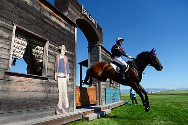 Katherine Robinson rides Outrageous Dance through the saloon obstacle in the Open Intermediate cross-country division during The Event at Rebecca Farm on Friday. (Casey Kreider/Daily Inter Lake)