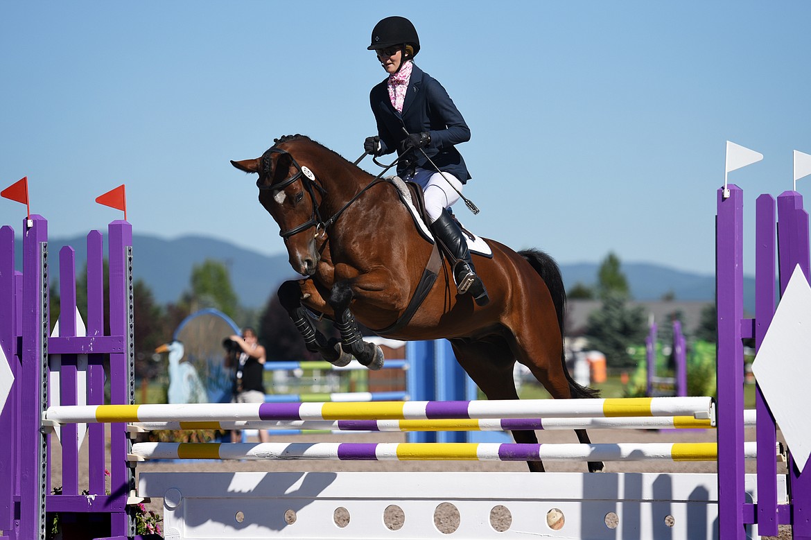 Andora Tutvedt rides ADR&#146;s Fausto over a jump in the Senior Open Novice B show jumping division during The Event at Rebecca Farm on Friday. (Casey Kreider/Daily Inter Lake)