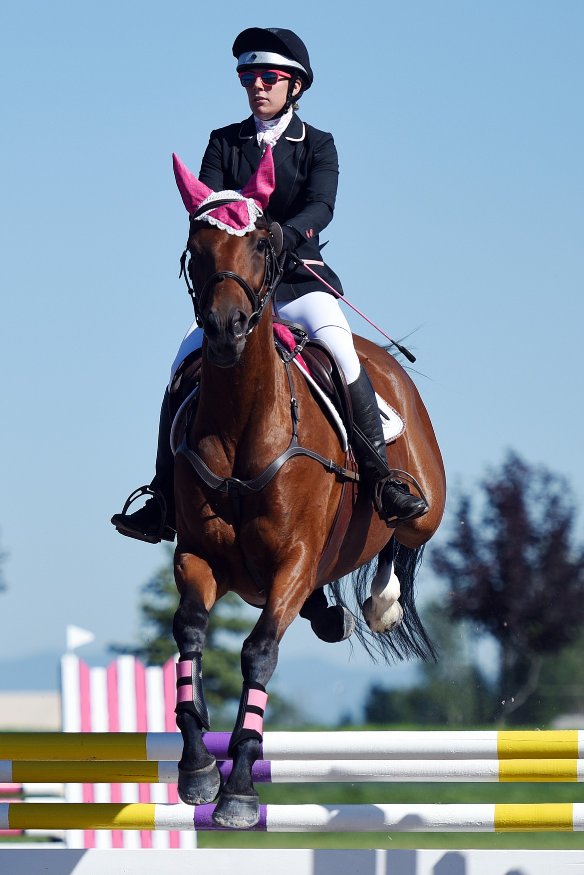 Bryanna Tomayer rides Bad Moon Rising over a jump in the Senior Open Novice B show jumping division during The Event at Rebecca Farm on Friday. (Casey Kreider/Daily Inter Lake)