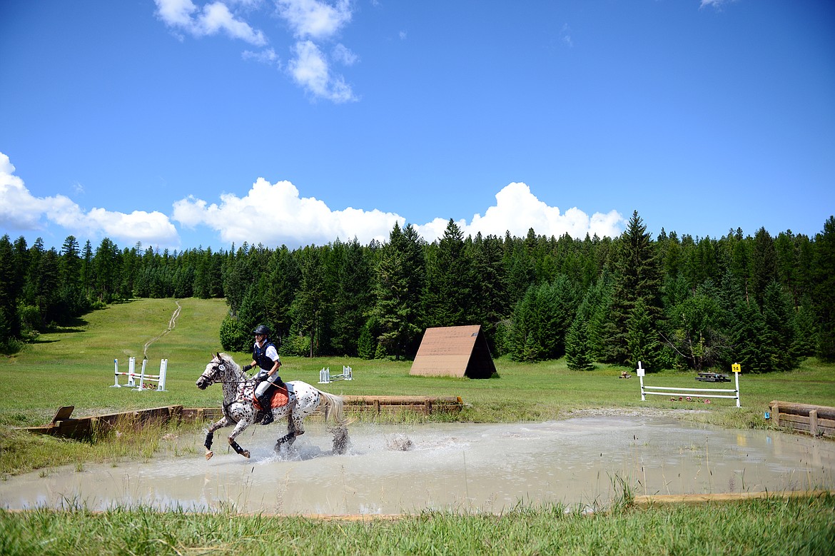 A horse and rider navigate a water obstacle on the cross-country course at the Herron Park Event Derby at Herron Park on July 20. (Casey Kreider/Daily Inter Lake)