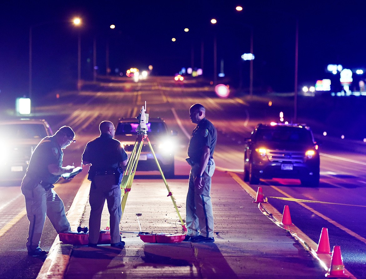 Montana Highway Patrol troopers investigate the scene of a shooting Wednesday night on U.S. 93 near Happy Valley. (Brenda Ahearn/Daily Inter Lake)