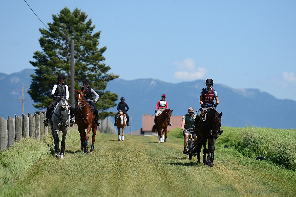 Horses and riders walk a portion of the cross-country course at Rebecca Farm on Wednesday. (Casey Kreider/Daily Inter Lake)
