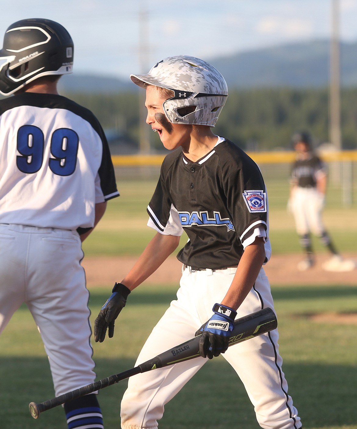 Coeur d&#146;Alene&#146;s Travis Usdrowski celebrates after crossing home plate for a score in Little League state 12U playoff game against Southwest Ada on Friday.