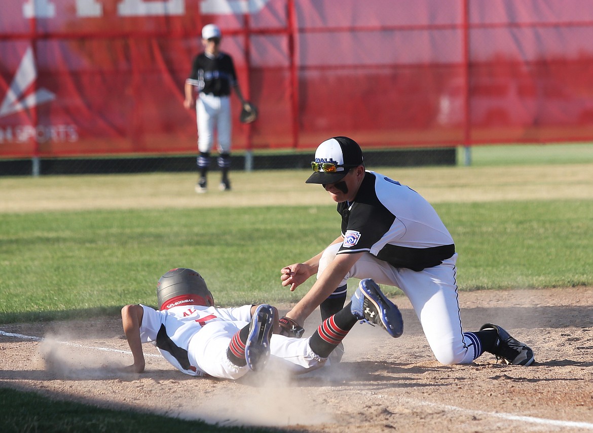 Southwest Ada baserunner Jacob Allen slides safely back to third base before Coeur d&#146;Alene&#146;s Owen Mangini can apply the tag during a pickle in a 12U (Majors) state playoff game on Friday at Croffoot Park in Hayden.