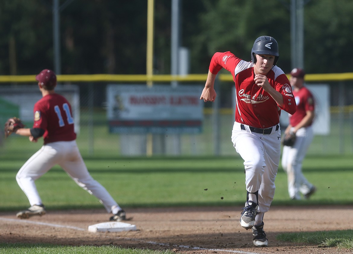 Coeur d&#146;Alene Lumberman Breyson Coppess tags from third base and races home for the run in an American Legion game against the Prairie Cardinals.