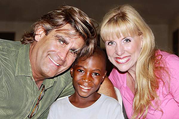 Michael and Pam Rozell pose with one a child from Ugana who was involved in the Potter’s Field Kids program in 2011. (Courtesy photo)