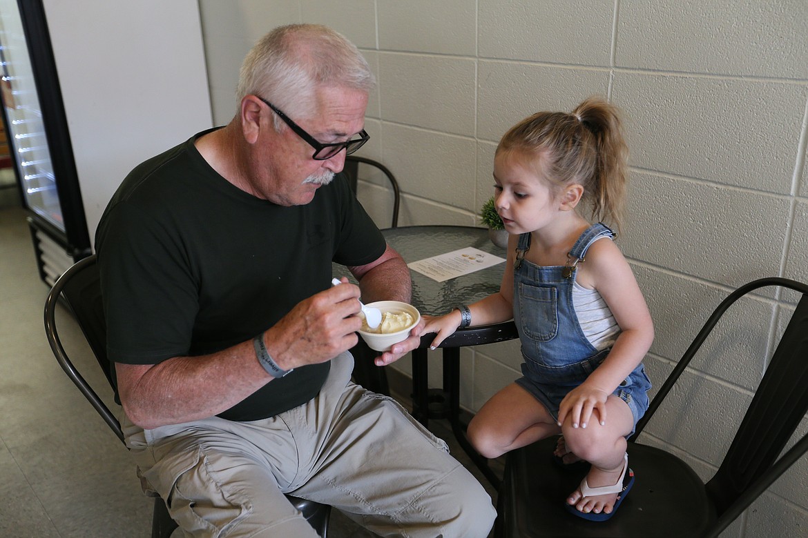 Bob Niece sharing some of his ice cream with granddaughter Malone Steiner, 2, at Abi's Ice Cream. JULIA BENNETT/ Press