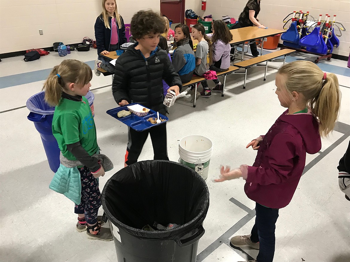 (Courtesy photo)
Washington Elementary second graders educate a classmate on which items to put in the garbage and what could go in the bucket for farm animals during their efforts to reduce food waste this past year.